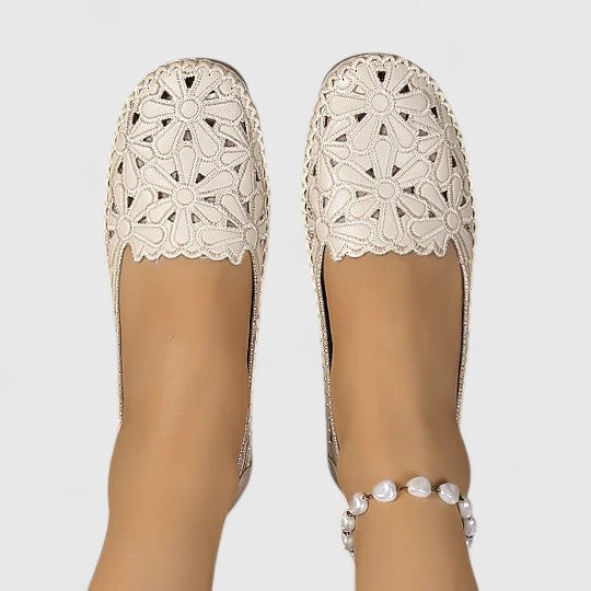 Women's perforated slip on flats showing slip-on construction and cushioned insole detail