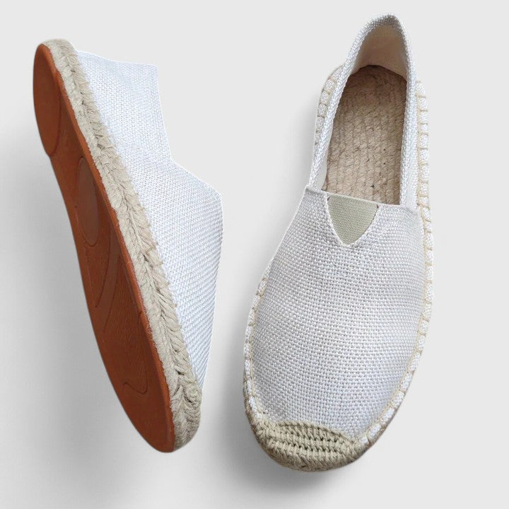 Women's orthopedic espadrilles with white canvas upper and natural jute sole on neutral background