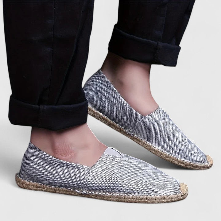 Bottom view of orthopedic espadrilles displaying brown rubber outsole with traction pattern