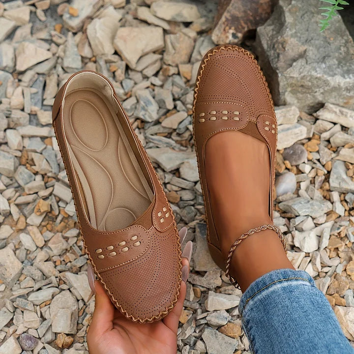 Close-up of women's orthopedic slip on loafers showcasing perforated detailing and cutout strap accent in beige