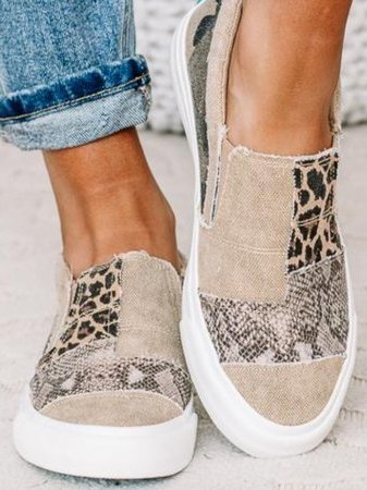 Detail of women's slip-on sneakers showing arch support footbed and easy-entry elastic gores for secure fit