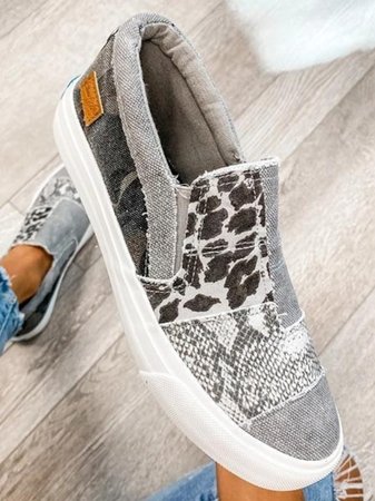 Top view of women's orthopedic loafers showing mixed-print canvas panels and slip-on construction with elastic sides