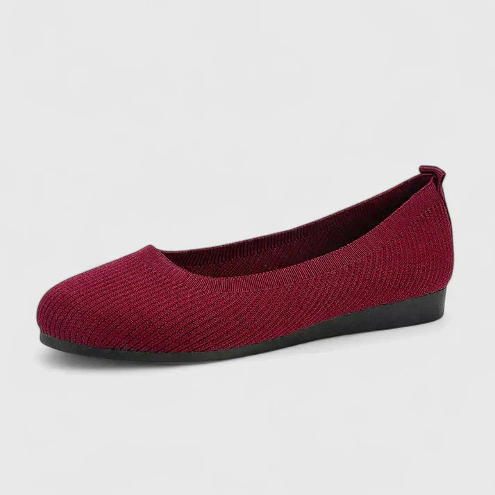Bottom view of black rubber outsole on women's orthopedic slip on shoe with grip pattern