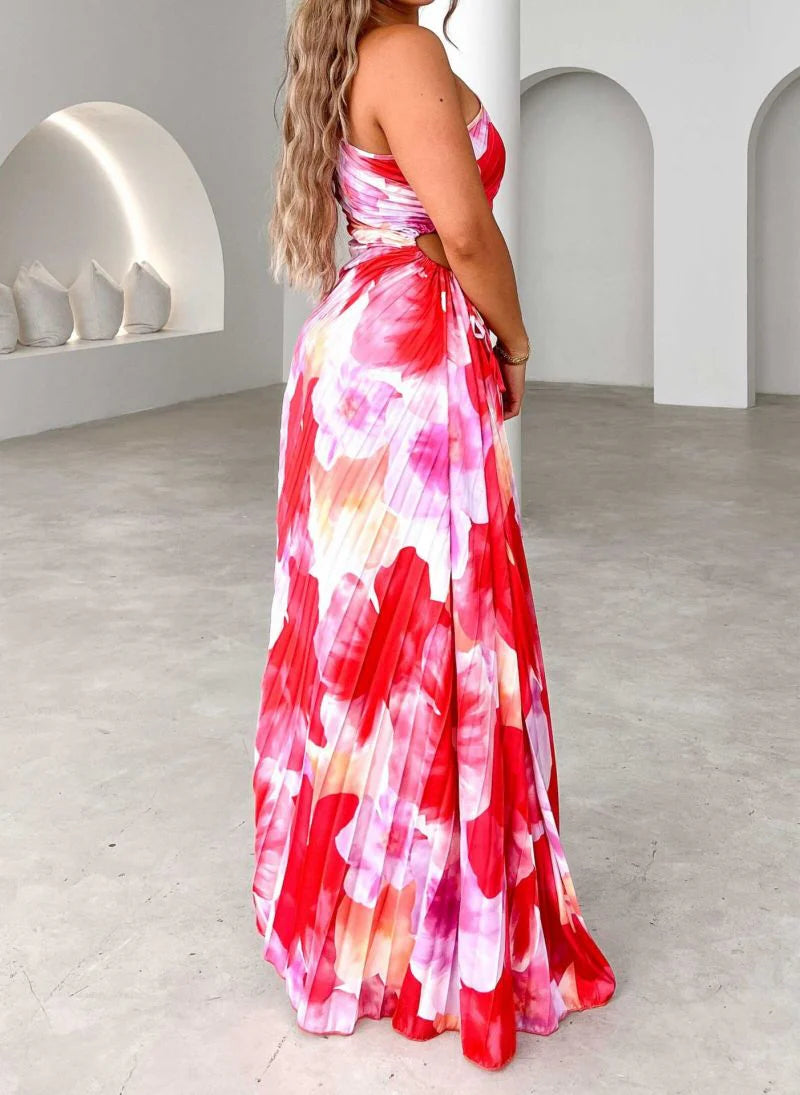 Asymmetric hem detail on flowing pleated summer dress with bold pattern