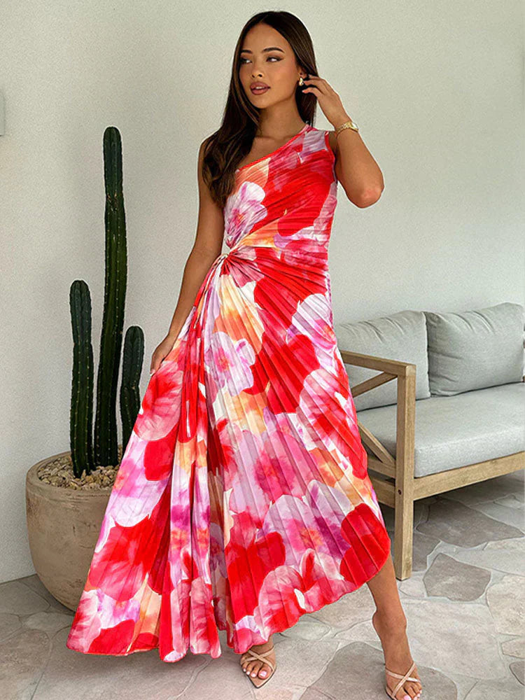 Back view of one shoulder maxi dress with pleated skirt and vibrant print