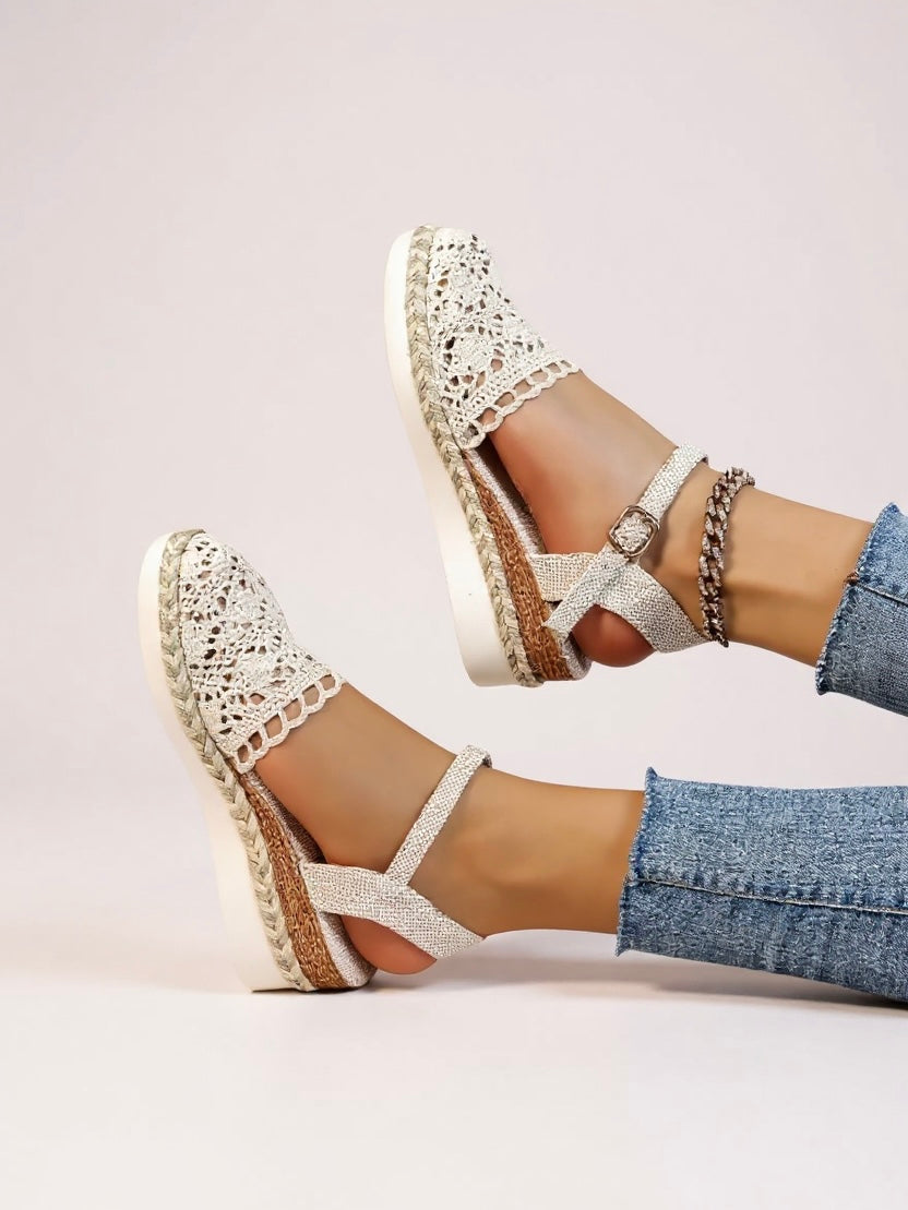 Side view of boho wedge espadrille sandals showing cross-over ankle strap with chain detail and platform height