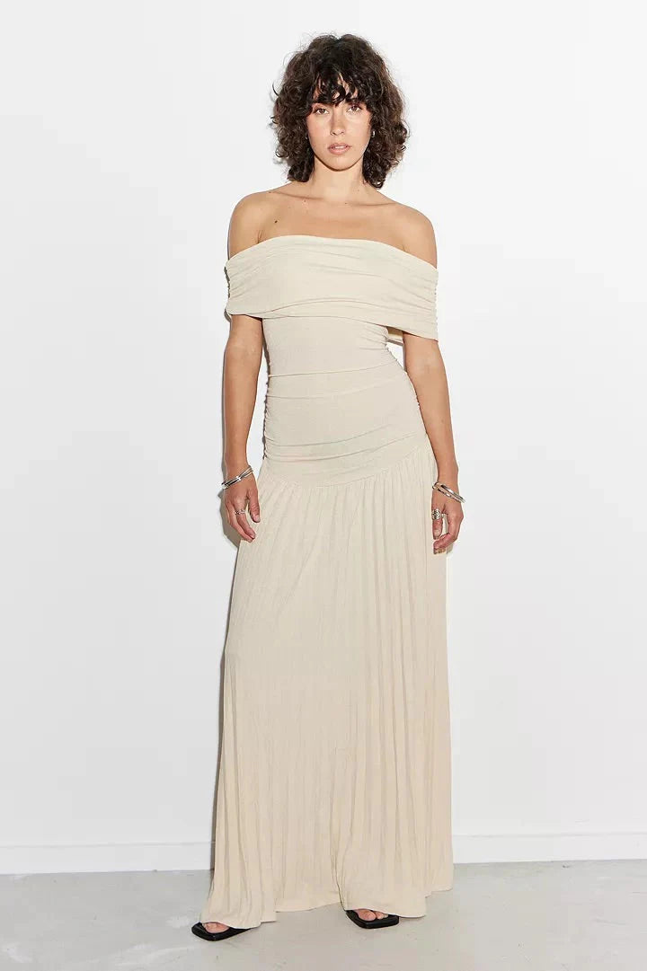 Detail shot of pleated skirt with smooth drape and movement