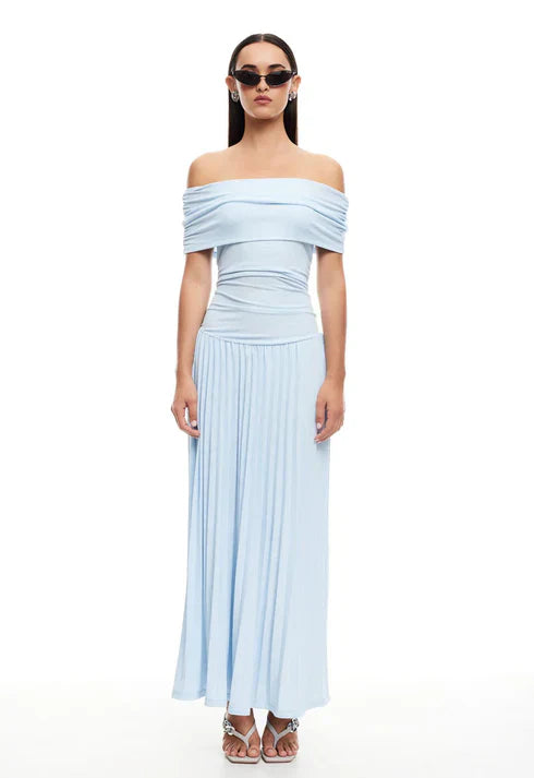 Detail of fitted waist and pleated skirt on flowing maxi dress