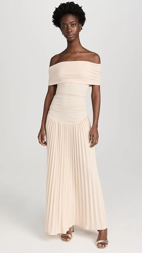 Model wearing off shoulder maxi dress with flowing pleated skirt