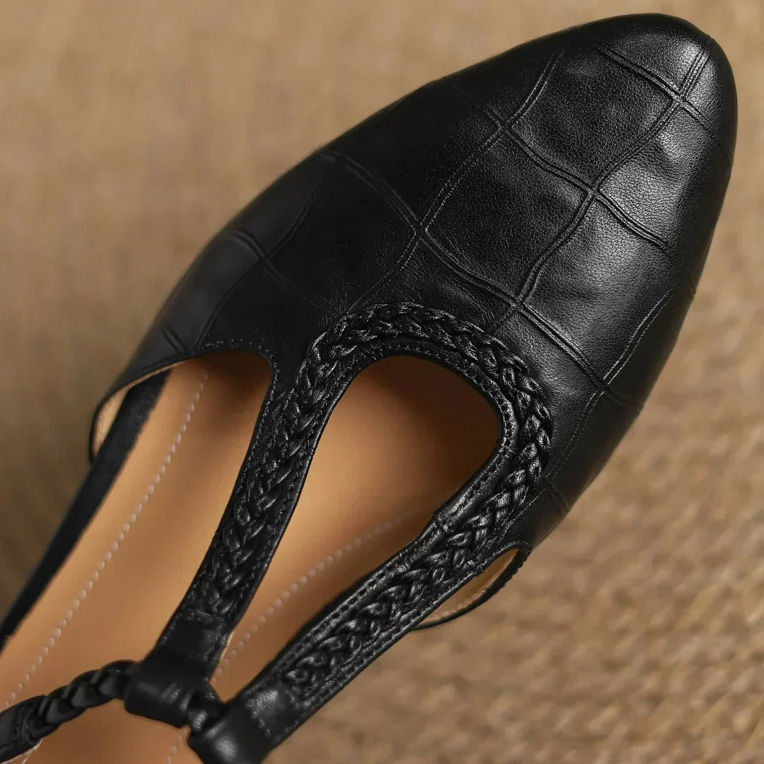 Close-up of structured leather upper and smooth finish on women's T-strap flats