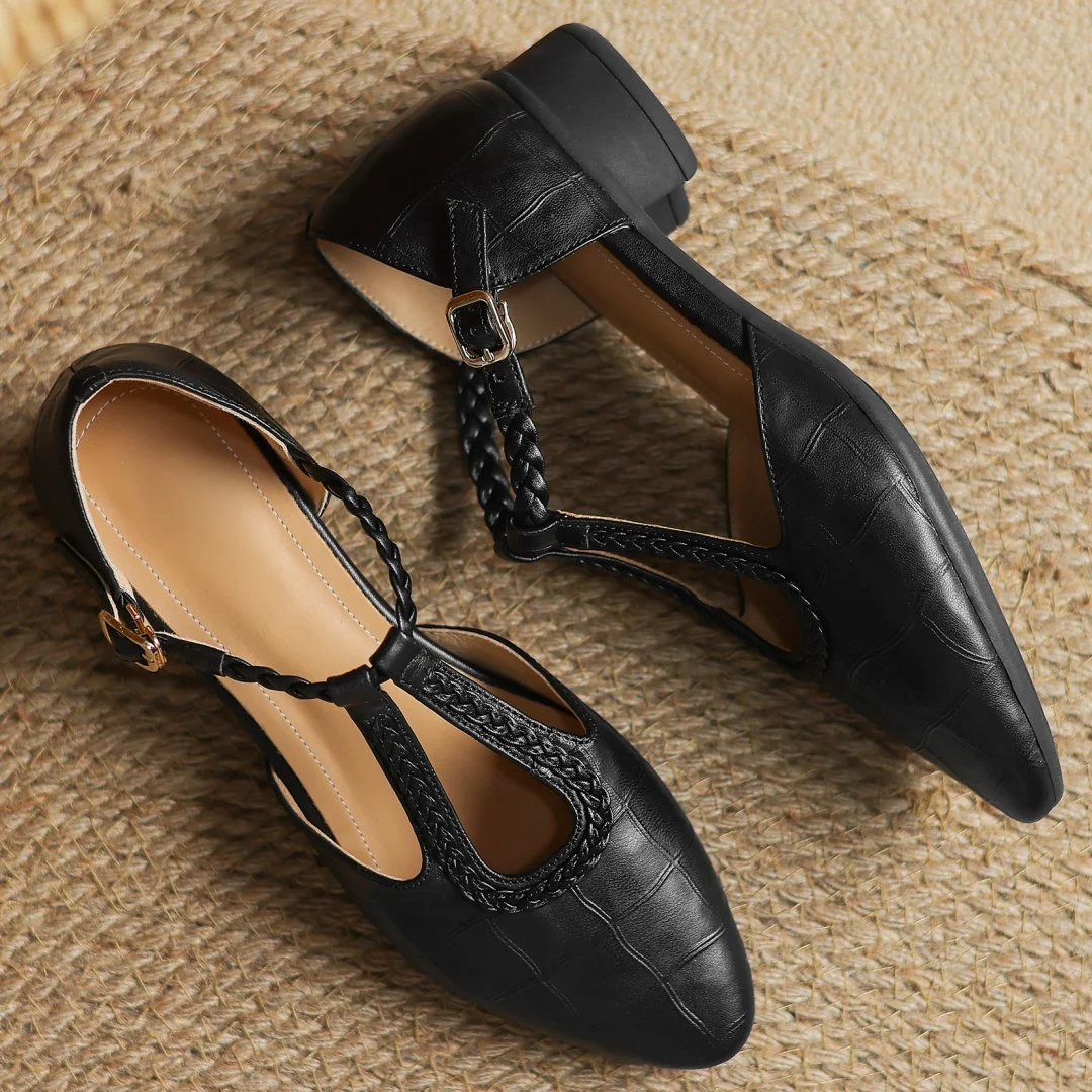 Black leather T-strap mary jane flats with braided strap and pointed toe design