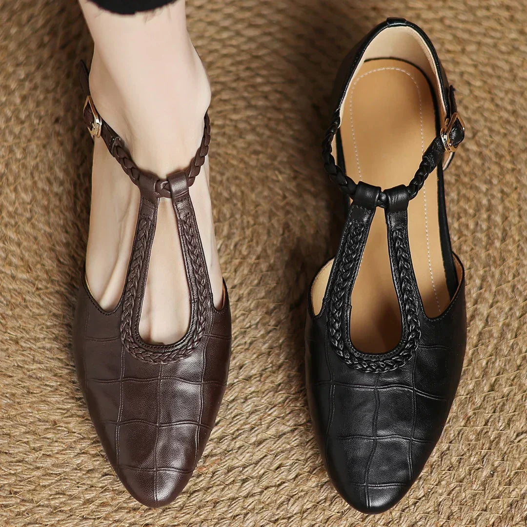 Women's pointed toe mary jane flats in black colorway with metal buckle closure