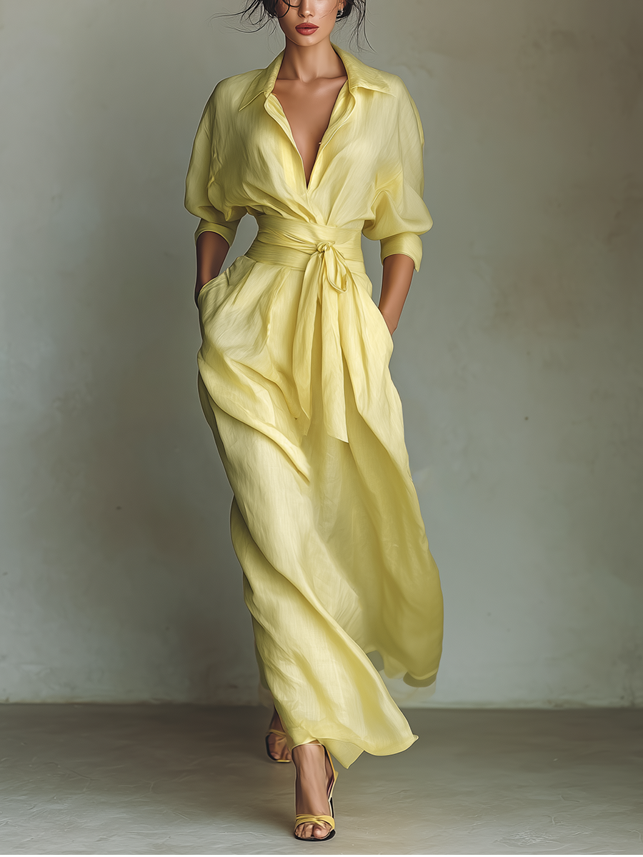 Woman wearing a yellow cotton linen maxi dress with deep V-neckline and tie waist, full-length view