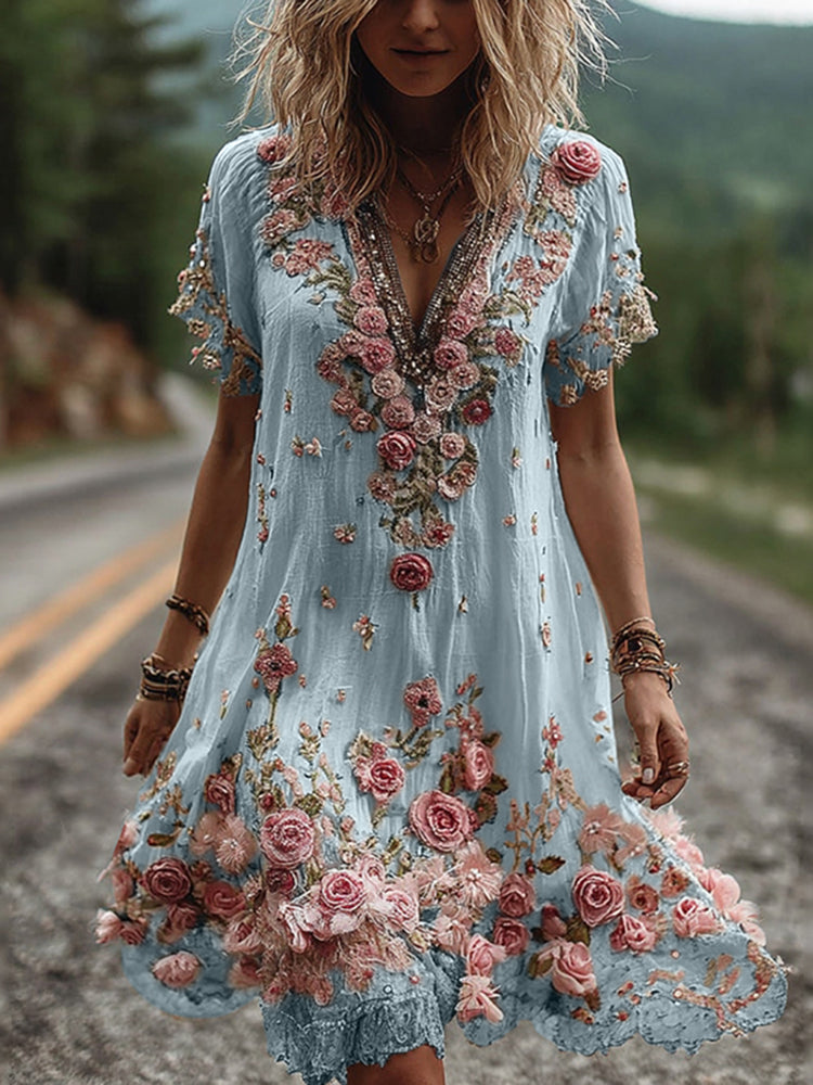 Side angle of embroidered V neck dress showing A-line silhouette and knee-length hem with floral appliqué border