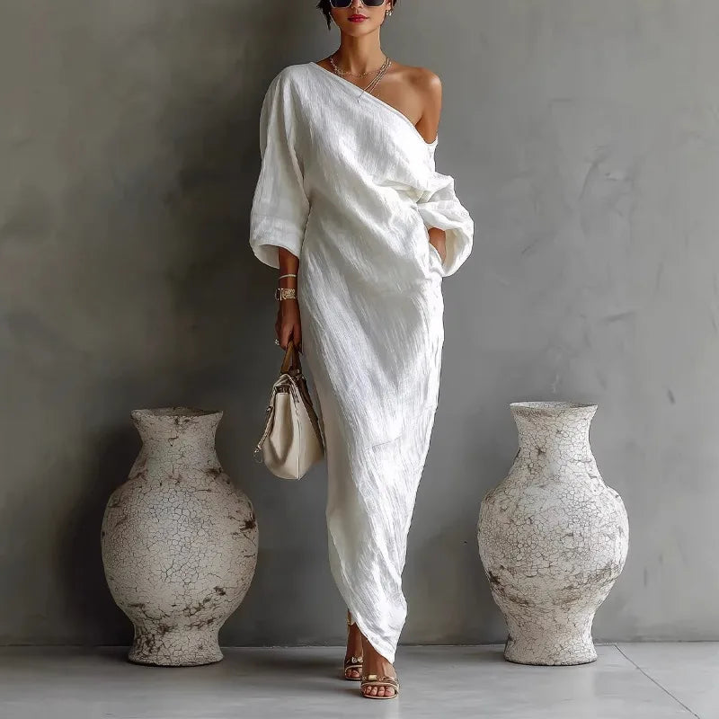 White linen one shoulder dress with asymmetrical hem and relaxed maxi length silhouette