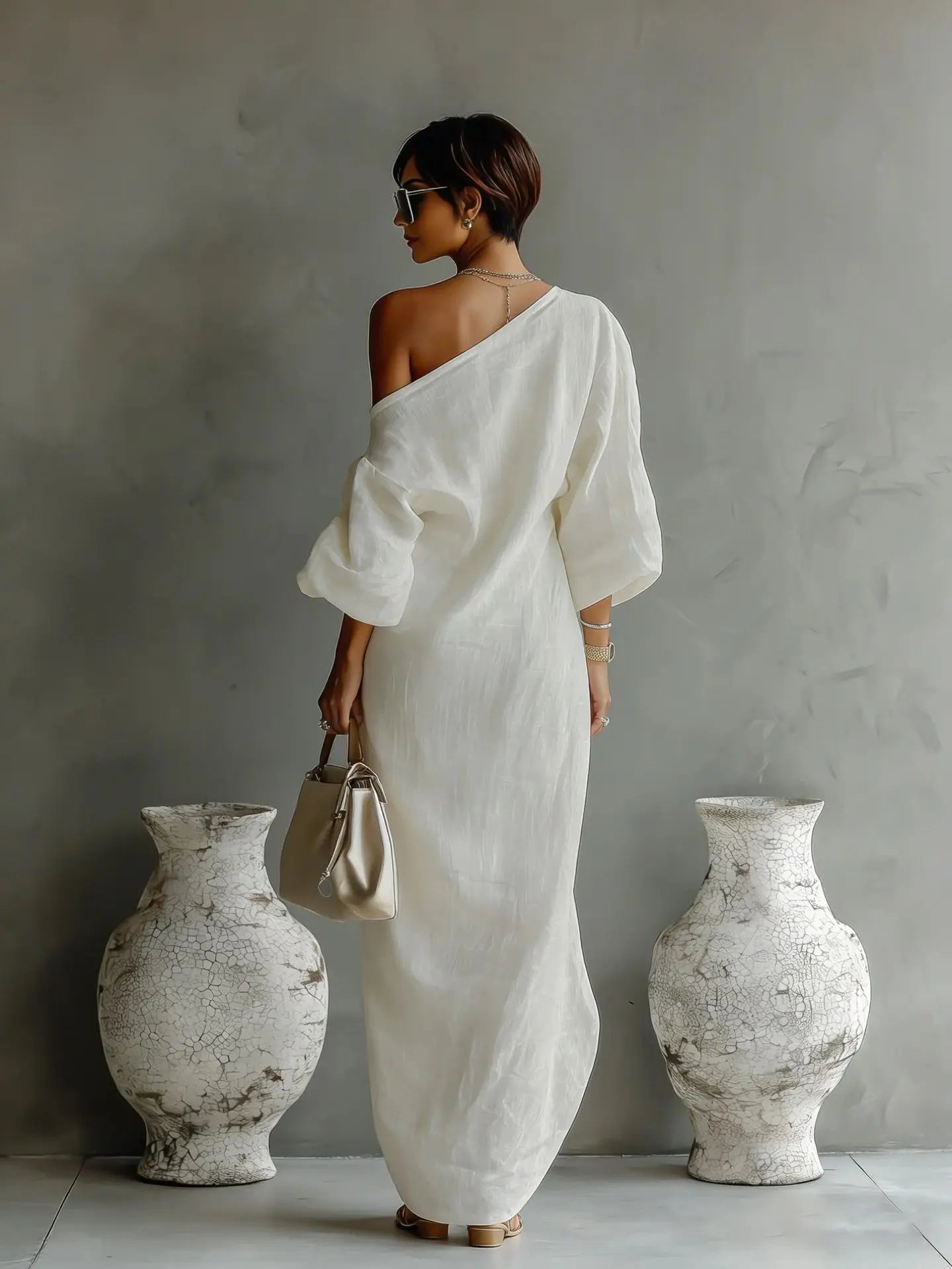 Detail of asymmetrical neckline on linen one shoulder dress with relaxed fit