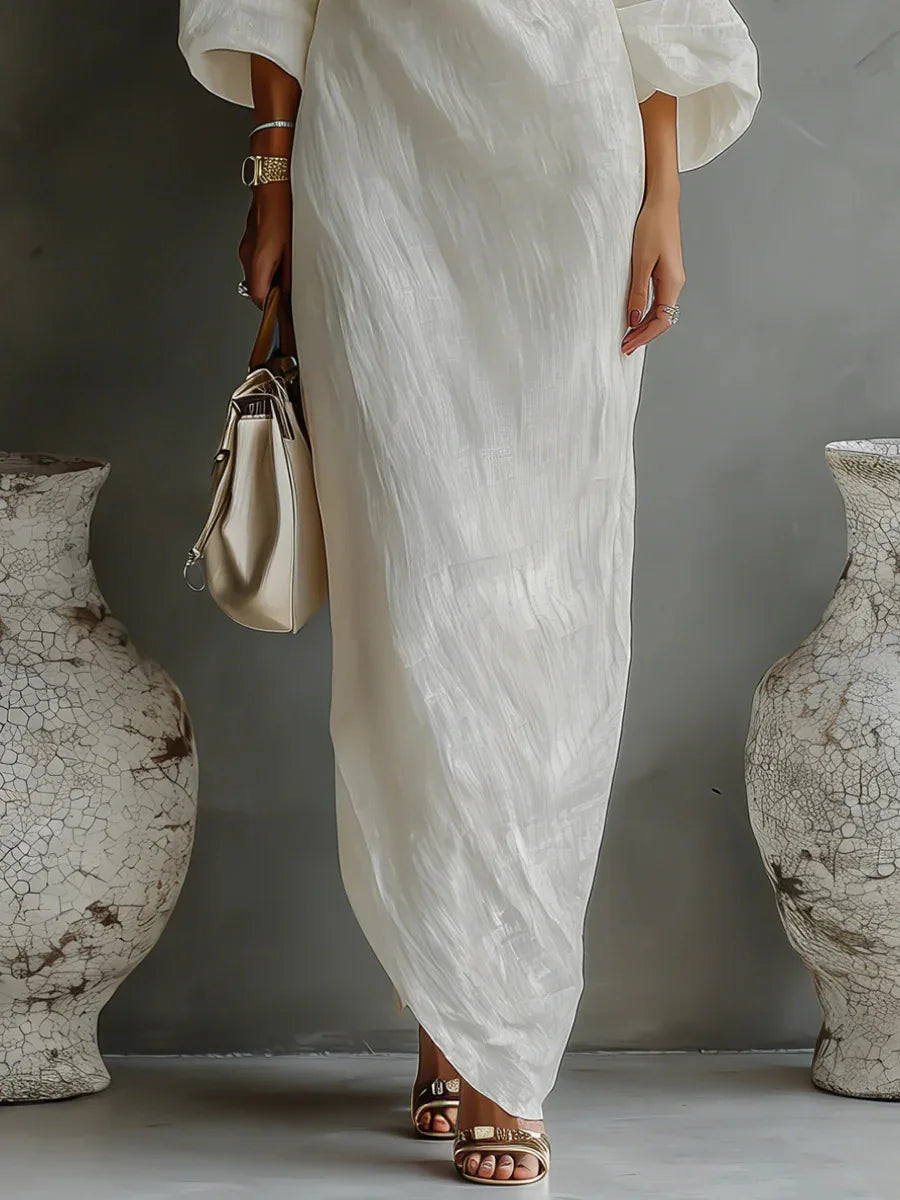 Full length view of white linen one shoulder dress with side pockets and maxi hem