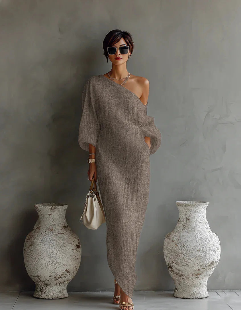 Close up of batwing sleeve detail on linen one shoulder dress with natural drape