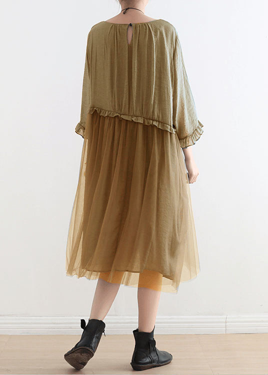 Detail shot of ruffled three-quarter sleeves and round neckline on chiffon dress