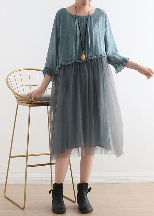 Side view of midi-length tulle dress showing flowing A-line silhouette and three-quarter ruffled sleeves