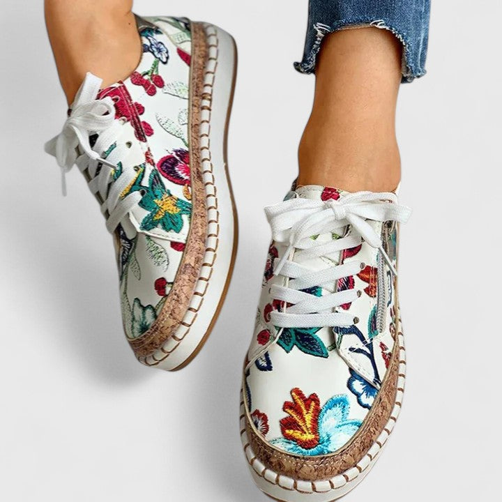 Women's orthopedic sneakers featuring colorful floral pattern and cushioned footbed support
