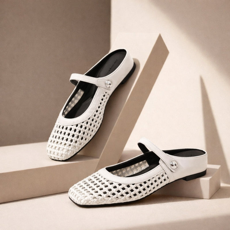 Close-up of woven Mary Jane mules featuring adjustable strap with button closure and textured metallic finish