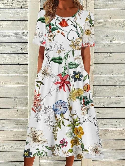 Close-up view of the Printed Floral Midi Dress showing gathered waist detail and all-over floral pattern on pale blue fabric