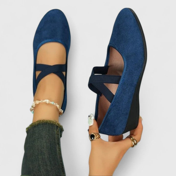 Close-up view of cross strap mary jane flats showing wrap-around strap detail and slip-on construction