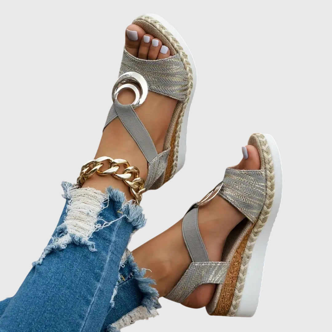 Overhead view of textured orthopedic sandals with metallic accent and cushioned sole designed for foot alignment