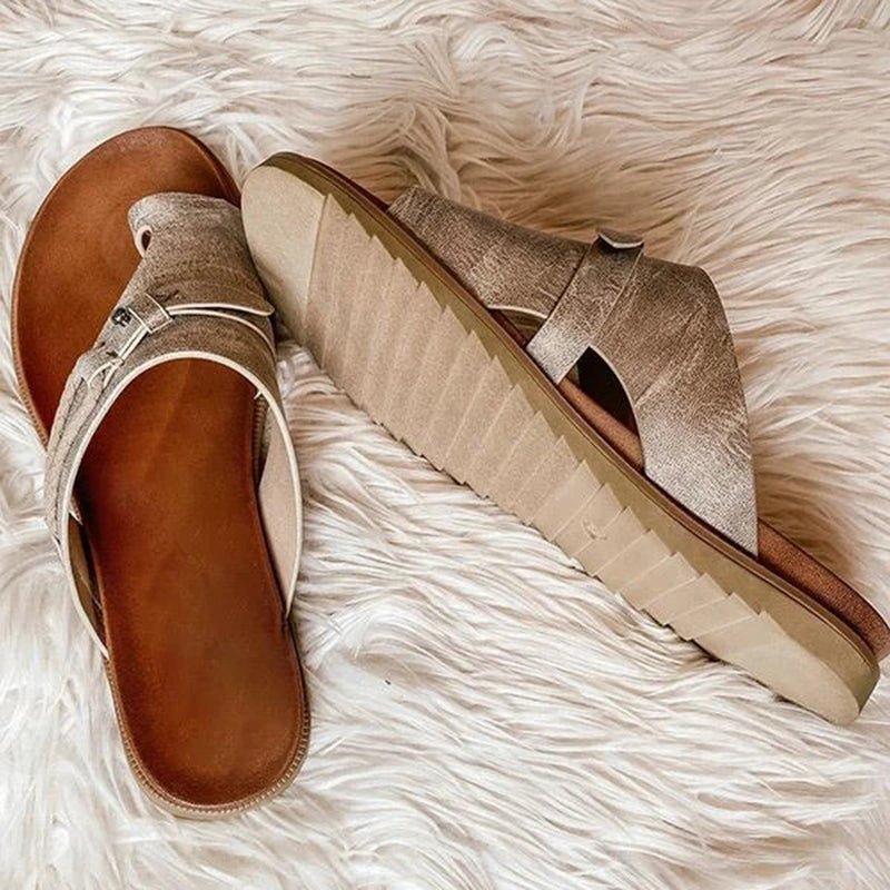 Close-up view of orthopedic sandals showing molded footbed and buckle strap detail across midfoot