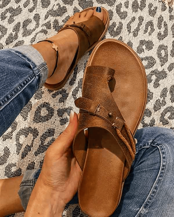Side angle of women's toe loop sandals displaying arch support and open-toe construction