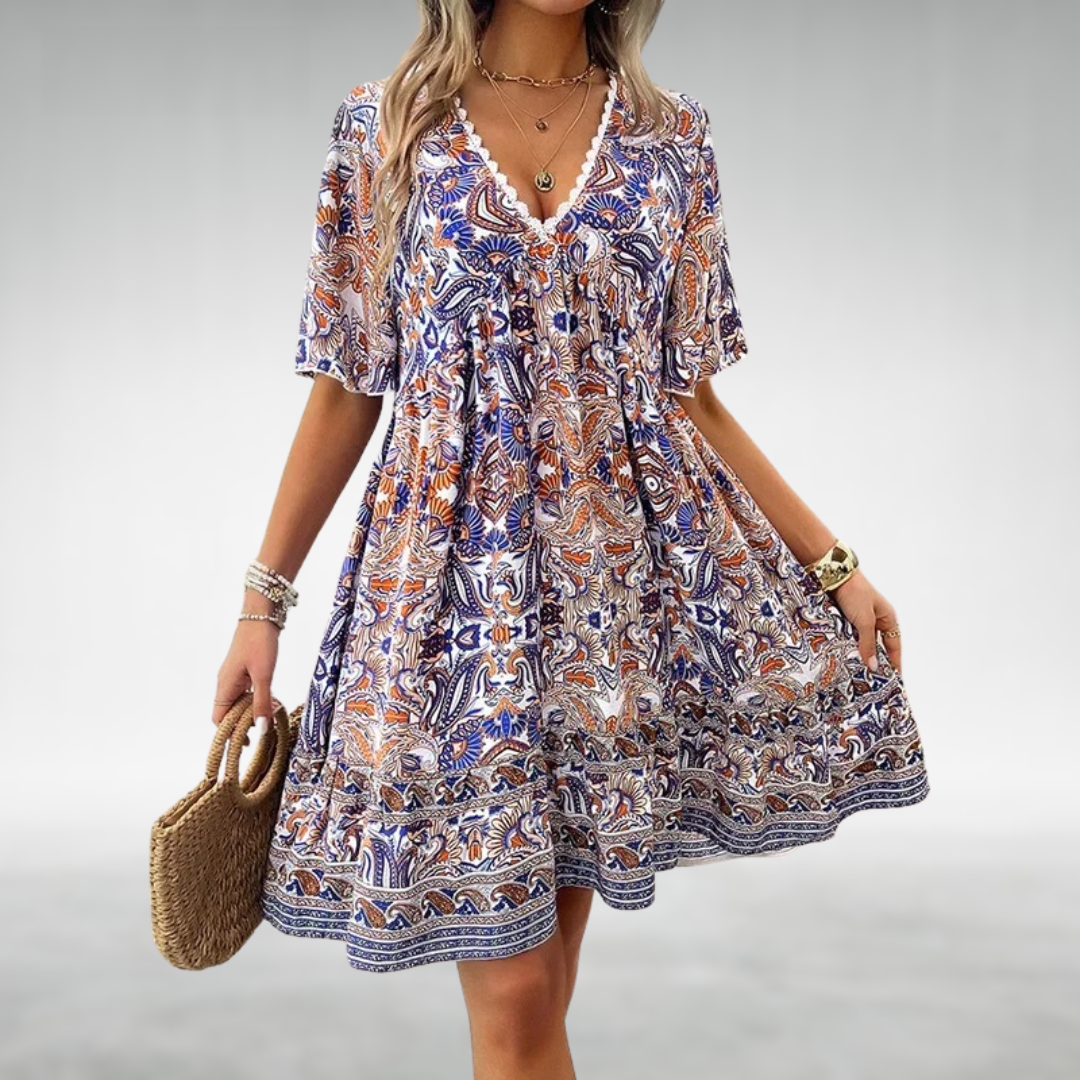 Side view of boho printed mini dress showing relaxed fit and empire waist gathering