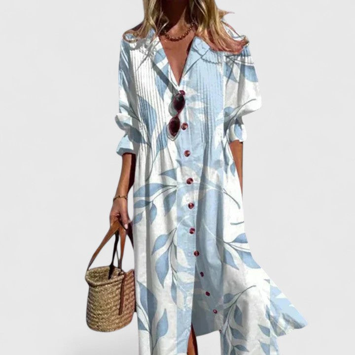 Woman wearing flowing leaf print maxi dress with button front and collared neckline for casual boho style