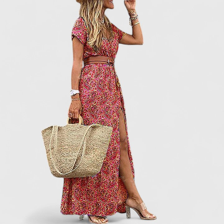 Back view of flowing maxi boho dress with side slit and relaxed silhouette in paisley pattern