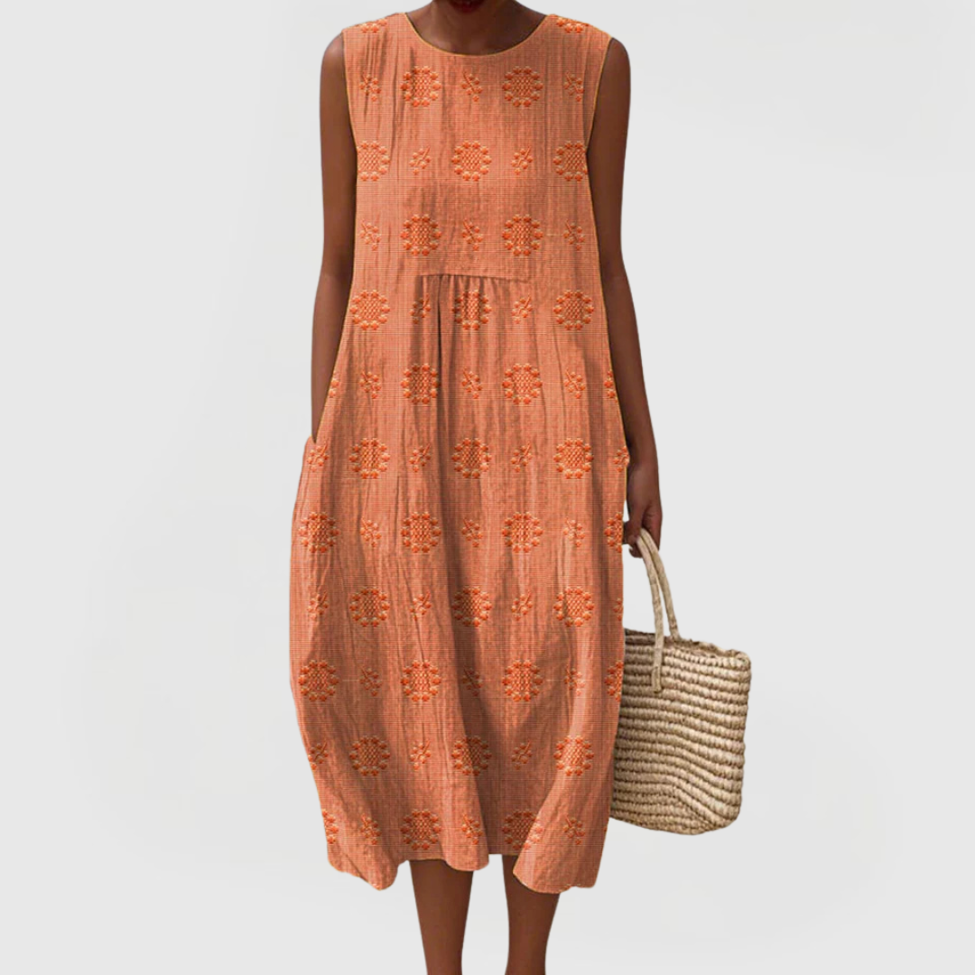 Back view of sleeveless linen midi dress showing flowing silhouette and embroidered detailing