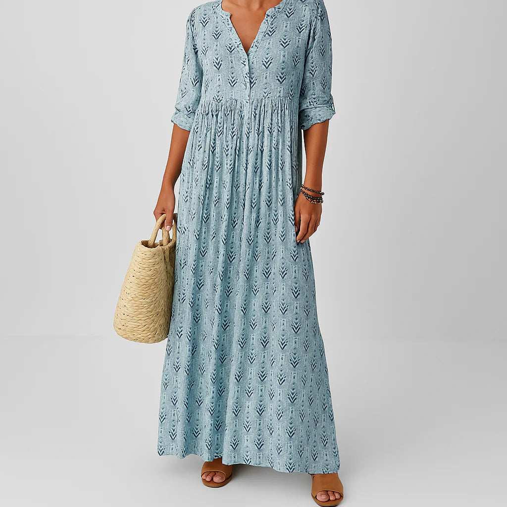 Woman wearing light blue Maxi Boho Print Dress with V-neckline and all-over boho print pattern