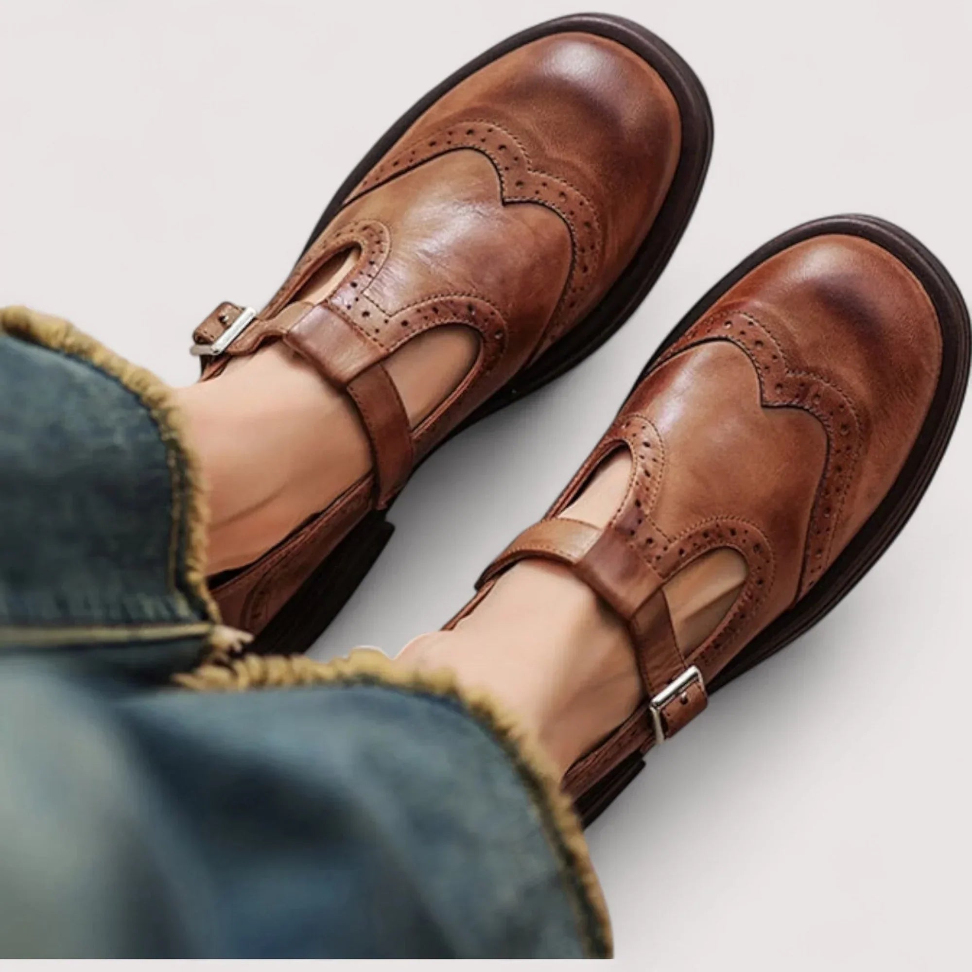 Skylar women's orthopedic mary jane shoes in brown with brogue detailing and adjustable buckle strap worn with jeans