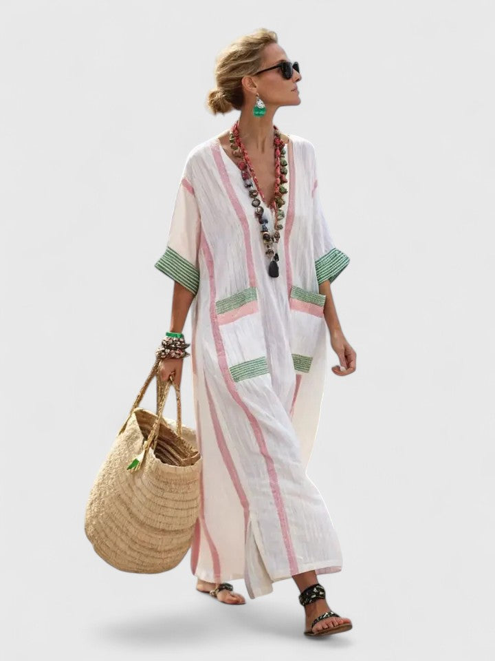 Woman wearing a white and pink striped Boho Maxi Dress with green contrast trim and V-neckline