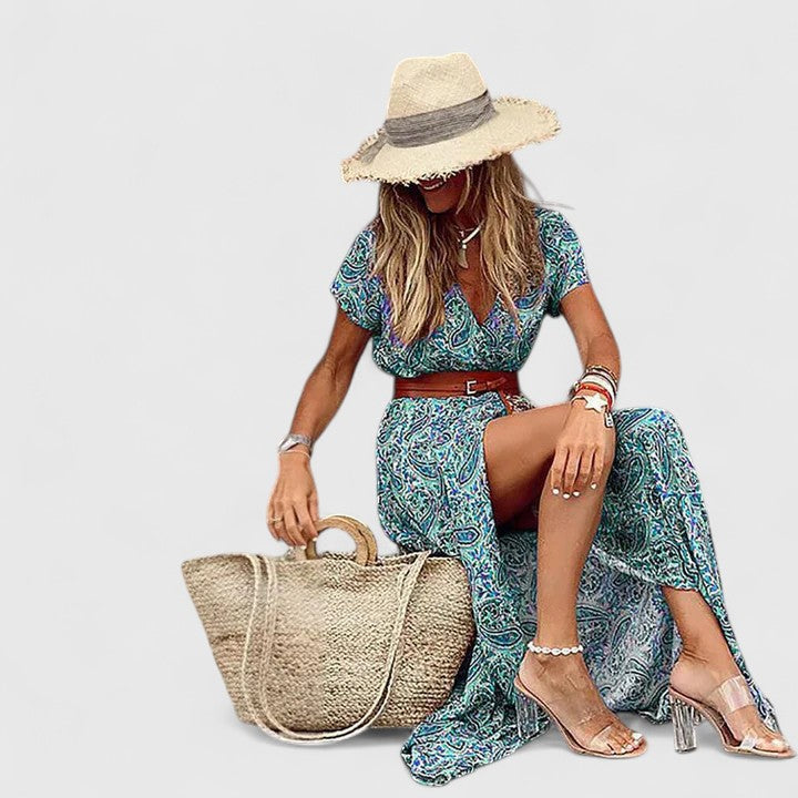 Woman styling sophisticated maxi dress with woven tote and sandals for summer