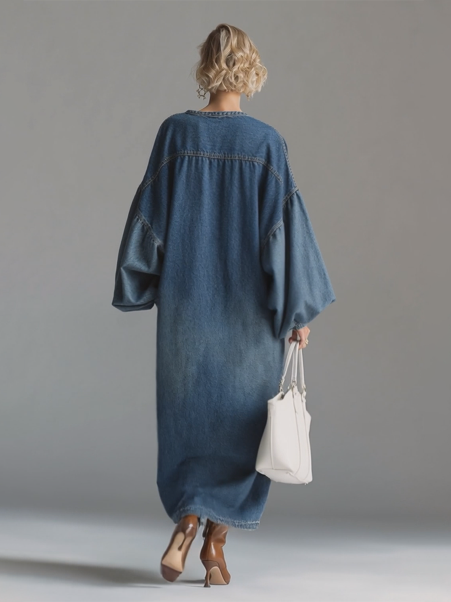 Close-up of button front placket and round neckline on women's blue denim maxi dress