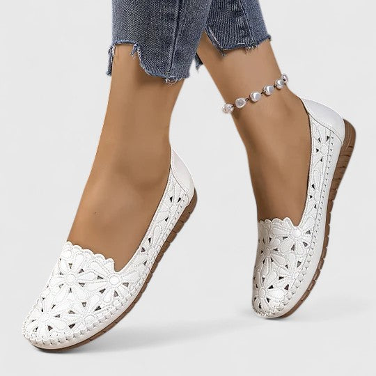Women's perforated slip on flats styled with cropped jeans and ankle bracelet for casual wear