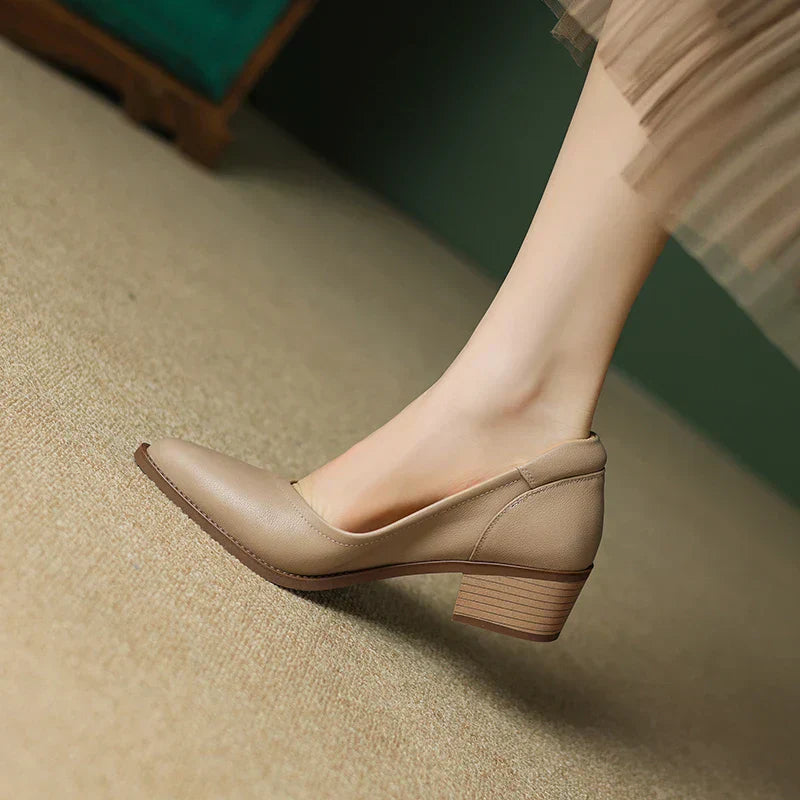 Side view of pointed toe slip on pumps showing mid-height block heel and smooth finish