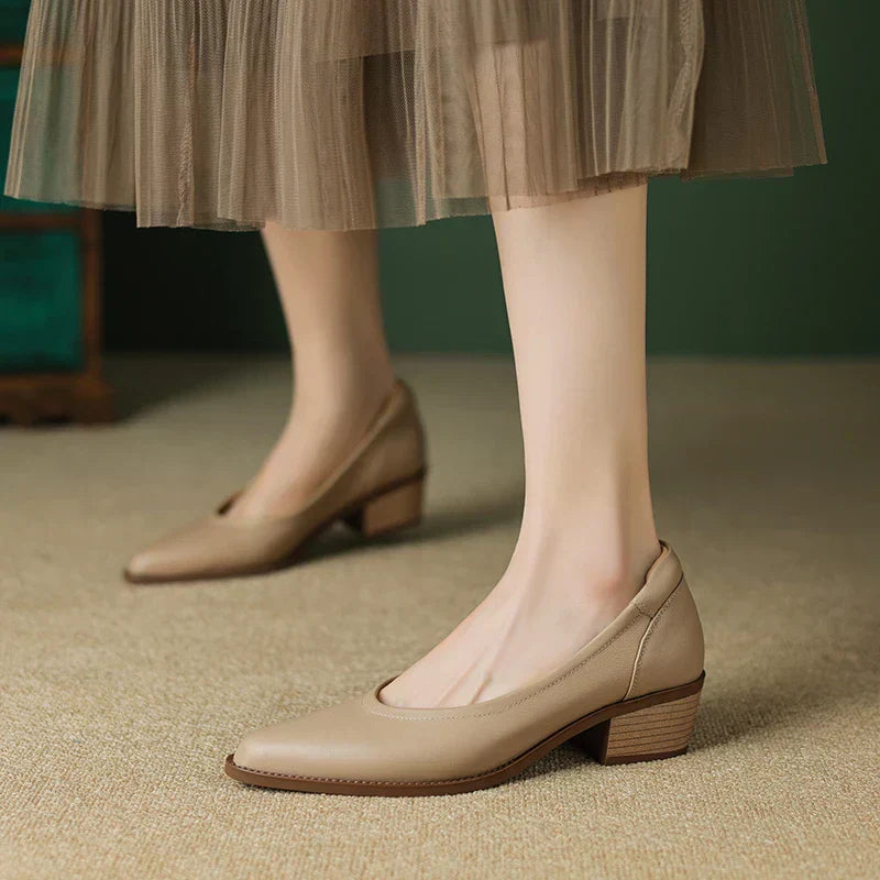 Close-up of women's block heel pumps with pointed toe silhouette and structured design