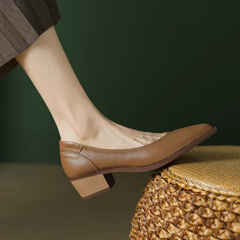 Beige pointed toe pumps with slip-on fit and mid heel for all-day wear