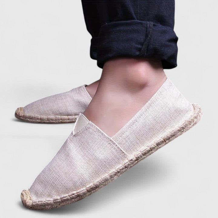 Pair of white orthopedic espadrilles with natural jute detailing and rubber sole
