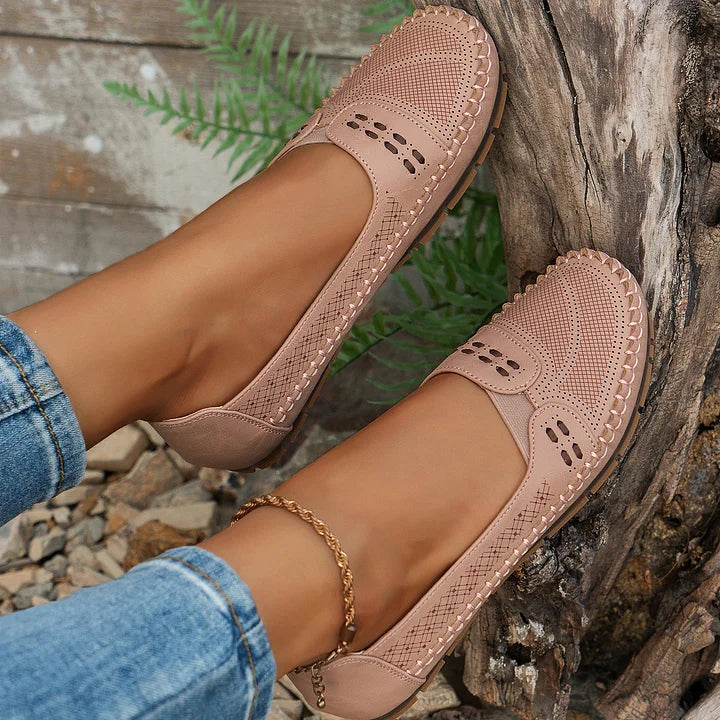 Close-up of decorative strap with cutout accents on women's orthopedic slip on loafers in brown