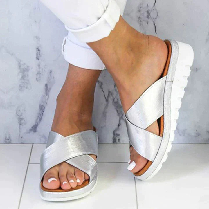 Woman wearing Women Summer Orthopedic Style Sandals with white pants on marble floor