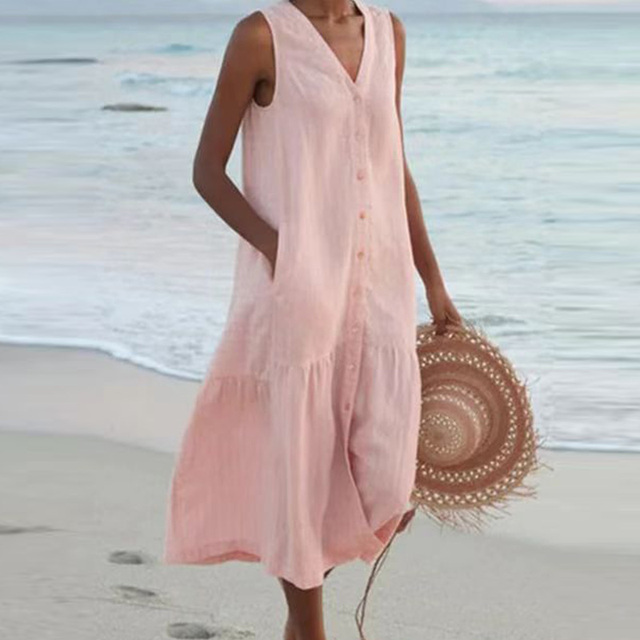 Back view of sleeveless linen beach dress with flowing tiered skirt and natural drape