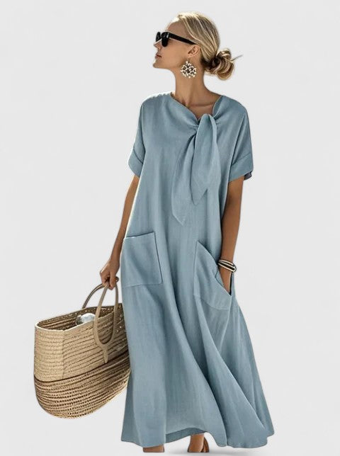 Close-up of tie neck detail on elegant summer dress with smooth fabric finish