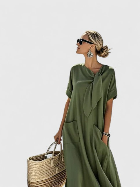 Model styling elegant summer dress for warm-weather occasions with statement earrings